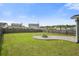 The expansive backyard features a privacy fence, fire pit, green grass, and a screened-in porch on the home at 476 Foxbank Plantation Blvd, Moncks Corner, SC 29461