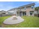 The backyard has a rock garden, fire pit, privacy fence, green grass, and a screened porch on the home at 476 Foxbank Plantation Blvd, Moncks Corner, SC 29461