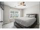 Bedroom with a queen-sized bed, a ceiling fan and a window overlooking the neighborhood at 476 Foxbank Plantation Blvd, Moncks Corner, SC 29461