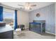 Bedroom featuring blue accents, patterned wallpaper, a ceiling fan, and a bright window at 476 Foxbank Plantation Blvd, Moncks Corner, SC 29461