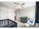 Bedroom featuring neutral tones, white seating, a crib, and a dark wood dresser at 476 Foxbank Plantation Blvd, Moncks Corner, SC 29461