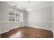 Bright dining room features hardwood floors, chair rail and classic chandelier at 476 Foxbank Plantation Blvd, Moncks Corner, SC 29461
