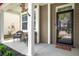Inviting front porch area with cozy seating, a storm door, and a patriotic American flag at 476 Foxbank Plantation Blvd, Moncks Corner, SC 29461