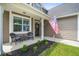 Cozy front porch featuring comfortable seating and a welcoming American flag at 476 Foxbank Plantation Blvd, Moncks Corner, SC 29461