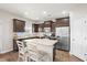 Well-lit kitchen with stainless steel appliances, dark cabinetry, granite countertops and an eat-in kitchen island at 476 Foxbank Plantation Blvd, Moncks Corner, SC 29461