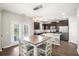 Eat-in kitchen with stainless appliances, dark cabinets, and island seating at 476 Foxbank Plantation Blvd, Moncks Corner, SC 29461