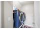 Modern laundry room with a blue washer and dryer and white walls at 476 Foxbank Plantation Blvd, Moncks Corner, SC 29461