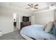 Bedroom with neutral colors, carpet, ceiling fan, TV over a dresser, and a view into the bathroom at 476 Foxbank Plantation Blvd, Moncks Corner, SC 29461
