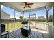 Screened porch with a ceiling fan, outdoor furniture, and a view of the backyard at 476 Foxbank Plantation Blvd, Moncks Corner, SC 29461