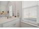 Half-bathroom featuring modern fixtures, a clean countertop, and a window for natural light at 500 W Respite Ln, Summerville, SC 29483