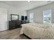 Cozy bedroom with hardwood floors, large windows, and stylish furnishings at 500 W Respite Ln, Summerville, SC 29483