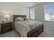 Serene bedroom featuring a wooden bed frame, soft bedding, and a well-lit nightstand at 500 W Respite Ln, Summerville, SC 29483