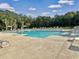 Community pool surrounded by lounge chairs and lush trees at 500 W Respite Ln, Summerville, SC 29483