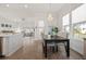 Open concept dining room featuring a chandelier, large windows, and modern decor at 500 W Respite Ln, Summerville, SC 29483