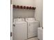 Efficient laundry area with washer, dryer, and storage baskets on shelving at 500 W Respite Ln, Summerville, SC 29483
