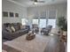 Bright living room featuring a comfortable gray leather couch, stylish striped chairs, and lots of natural light at 500 W Respite Ln, Summerville, SC 29483