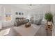 Bright living room with neutral tones, hardwood floors, a comfortable sofa, and plenty of natural light at 500 W Respite Ln, Summerville, SC 29483