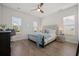 Serene primary bedroom with hardwood floors, soft lighting, and a luxurious upholstered bed at 500 W Respite Ln, Summerville, SC 29483