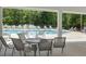 Covered poolside seating area with chairs and tables overlooking the pool at 500 W Respite Ln, Summerville, SC 29483
