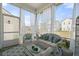 Relaxing screened-in porch with comfortable wicker furniture and views of the neighborhood at 500 W Respite Ln, Summerville, SC 29483