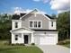 Charming two-story home with a landscaped yard, a two-car garage, and a welcoming front porch at 526 Pender Woods Dr, Summerville, SC 29486