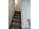 Staircase featuring neutral carpet and white trim, leading to the upper level of the home at 526 Pender Woods Dr, Summerville, SC 29486