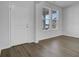 Inviting entryway with wood-look floors, natural light, and a white front door at 553 Richfield Way, Summerville, SC 29486