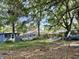 Exterior backyard view shows a shed and trailer amongst foliage and debris at 5901 Sedgefield Dr, Hanahan, SC 29410