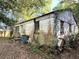 Exterior view of neglected house with overgrown vegetation at 5901 Sedgefield Dr, Hanahan, SC 29410
