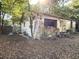 Exterior view of house with decaying wood, neglected yard, and overgrown vegetation at 5901 Sedgefield Dr, Hanahan, SC 29410