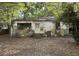 Exterior shot of a home in disrepair with missing roof shingles and a leaf-covered yard at 5901 Sedgefield Dr, Hanahan, SC 29410
