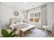 Bright bedroom with a beige padded headboard, and a decorative mirror above the bed at 606 Dunswell Dr, Summerville, SC 29486