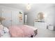 Bright bedroom with white furniture and pink patterned wallpaper at 606 Dunswell Dr, Summerville, SC 29486