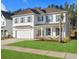 Beautiful two-story home with white siding, shutters, and a manicured green lawn on a sunny day at 606 Dunswell Dr, Summerville, SC 29486