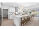 Bright, modern kitchen with white cabinets, quartz countertops, and a large island with seating at 606 Dunswell Dr, Summerville, SC 29486