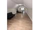 Spacious attic with light-toned walls, vinyl flooring, a black futon, and a queen-sized bed at 620 Coral Acres Dr, Moncks Corner, SC 29461