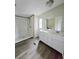 Bathroom featuring a double sink vanity, vinyl floors, and a tiled shower at 620 Coral Acres Dr, Moncks Corner, SC 29461