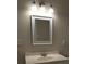 Well-lit bathroom featuring a white vanity with a sink, a chrome faucet, and a framed mirror above at 620 Coral Acres Dr, Moncks Corner, SC 29461