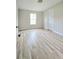 Neutral bedroom features wood look floors, a window, and a white door at 620 Coral Acres Dr, Moncks Corner, SC 29461