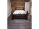 Bedroom with dark-wood accent wall, matching floors, and a decorative bed centered in the room at 620 Coral Acres Dr, Moncks Corner, SC 29461