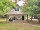 Charming house with a front porch and lush greenery, with a neatly mowed lawn, creating a cozy setting at 620 Coral Acres Dr, Moncks Corner, SC 29461