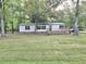 Charming home featuring a spacious front yard, a wooden deck, and a metal roof at 620 Coral Acres Dr, Moncks Corner, SC 29461