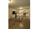 Bright kitchen with stainless steel appliances, white cabinetry, wood-look flooring, and a wooden center table at 620 Coral Acres Dr, Moncks Corner, SC 29461