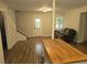Spacious living area featuring light-toned walls, wood-look flooring, and access to stairs and a couch at 620 Coral Acres Dr, Moncks Corner, SC 29461