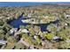 Aerial view showcasing houses along a lake, surrounded by lush green trees at 739 Stiles Dr, Charleston, SC 29412