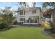 The back of the home offers a large deck, a paver patio, and lush landscaping at 739 Stiles Dr, Charleston, SC 29412