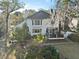 Back exterior view showcasing a two-story home, patio, deck, and landscaped yard with trees at 739 Stiles Dr, Charleston, SC 29412
