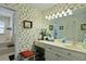 A quaint bathroom with floral wallpaper, vanity space, and an adjacent shower and tub at 739 Stiles Dr, Charleston, SC 29412