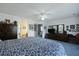 Comfortable bedroom with plush blue carpets, a patterned bed, and a view to the en suite bathroom at 739 Stiles Dr, Charleston, SC 29412