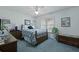 Cozy bedroom featuring a wooden bed frame, blue carpet, and a ceiling fan with light at 739 Stiles Dr, Charleston, SC 29412
